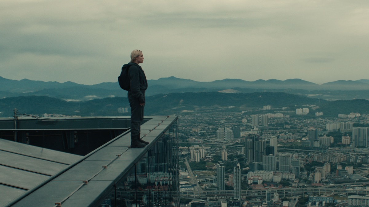 yelena on a ledge with a backpack on