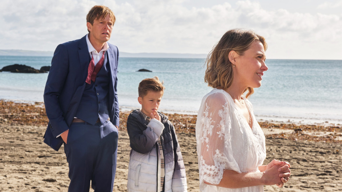 Humphrey Goodman, Martha Lloyd and their foster kid Ryan on the beach in the Beyond Paradise season 2 finale