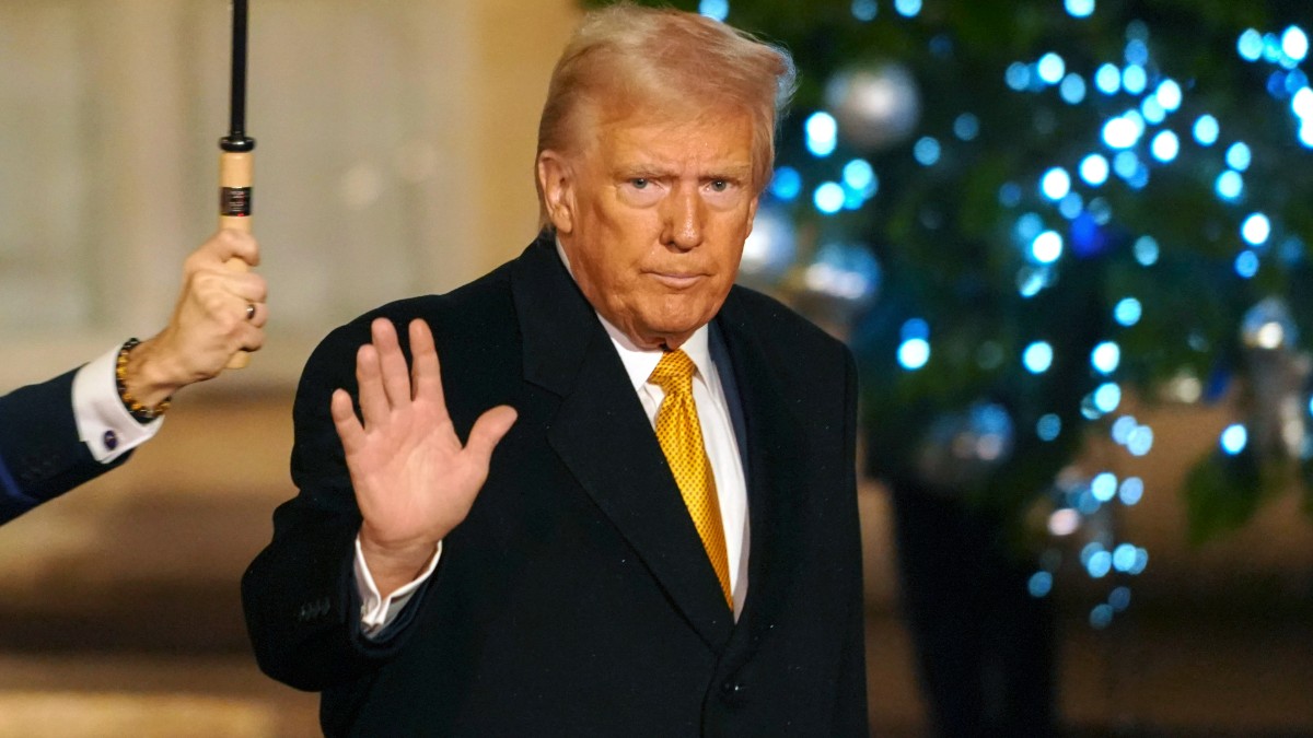 Donald Trump waves to the press in Paris, France