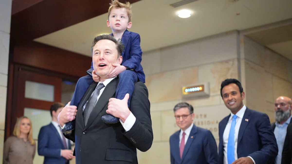 WASHINGTON, DC - DECEMBER 05: Tesla CEO Elon Musk, Co-Chair of the newly announced Department of Government Efficiency (DOGE) carries his son on his shoulders at the U.S. Capitol after a media availability with businessman Vivek Ramaswamy (2nd R), Co-Chair of the newly announced Department of Government Efficiency and Speaker of the House Mike Johnson (3rd R) (R-LA) on December 05, 2024 in Washington, DC. Musk and Ramaswamy are meeting with members of the U.S. Congress today about DOGE, a planned presidential advisory commission with the goal of cutting government spending and increasing efficiency in the federal workforce. ( (Photo by Andrew Harnik/Getty Images)