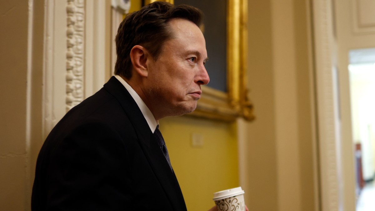 Elon Musk holding a coffee at Capitol Hill