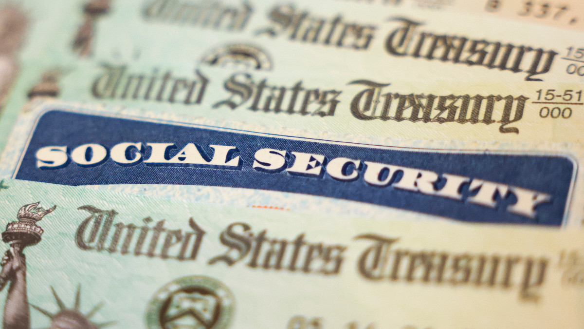 WASHINGTON, DC - OCTOBER 14: In this photo illustration, a Social Security card sits alongside checks from the U.S. Treasury on October 14, 2021 in Washington, DC. The Social Security Administration announced recipients will receive an annual cost of living adjustment of 5.9%, the largest increase since 1982. The larger increase is aimed at helping to offset rising inflation. (Photo illustration by Kevin Dietsch/Getty Images)