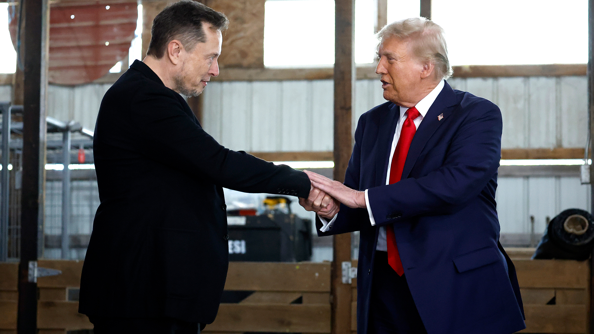 BUTLER, PENNSYLVANIA - OCTOBER 05: Elon Musk (L) shakes hands with Republican presidential nominee, former President Donald Trump back stage during a campaign rally at the Butler Farm Show grounds on October 05, 2024 in Butler, Pennsylvania. This is the first time that Trump has returned to Butler since he was injured during an attempted assassination on July 13. (Photo by Anna Moneymaker/Getty Images)