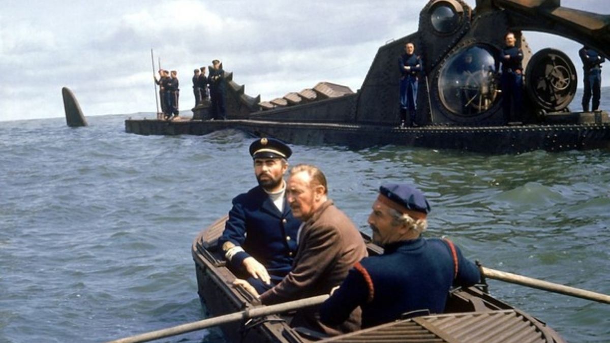 Three men sail in a row boat away near a submarine 