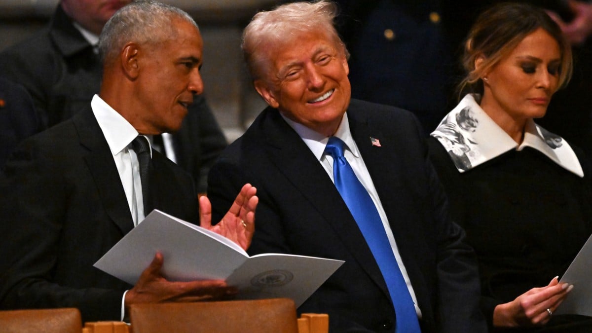 Barack Obama and Donald Trump chat at the Jimmy Carter's funeral