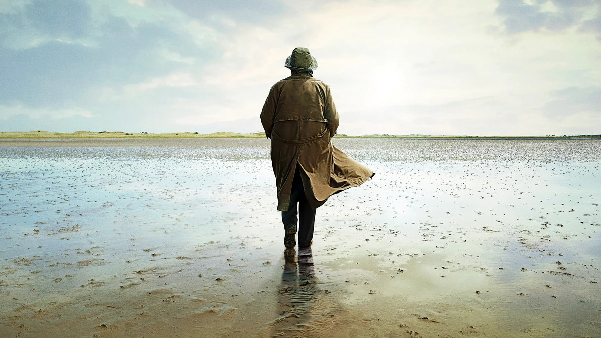 Brenda Blethyn as DCI Vera Stanhope, with her back turned to the camera as she walks across the beach in 'Vera'