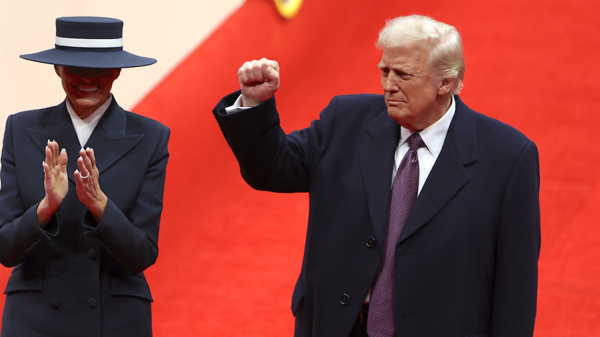 First lady Melania Trump and U.S. President Donald Trump backdropped by a red carpet, arrive during an indoor inauguration parade at the Capital One Arena