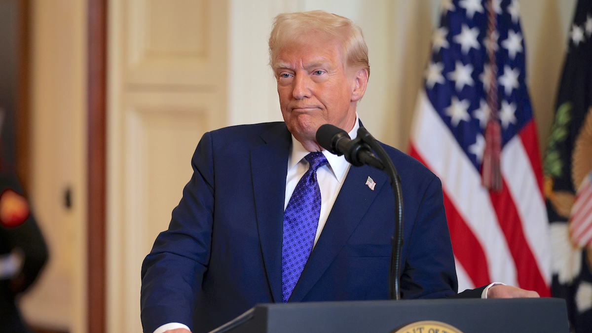 Donald Trump standing in front of the presidential seal, delivers remarks before signing the Laken Riley Act