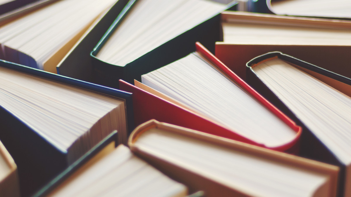 Many hardbound books background, selective focus - stock photo