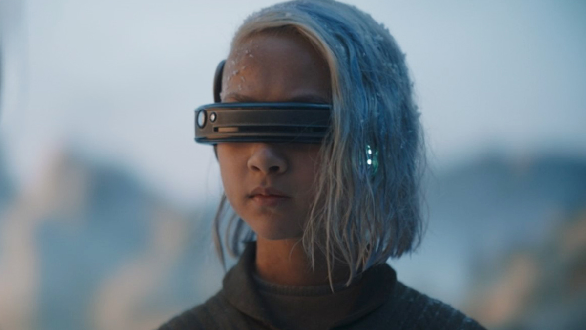 KB from Star Wars: Skeleton Crew stands in a garbage field with a visor over her eyes.