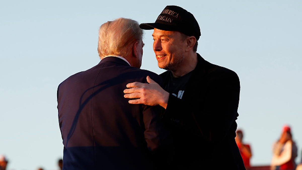 Donald Trump and Elon Musk embrace at a campaign rally