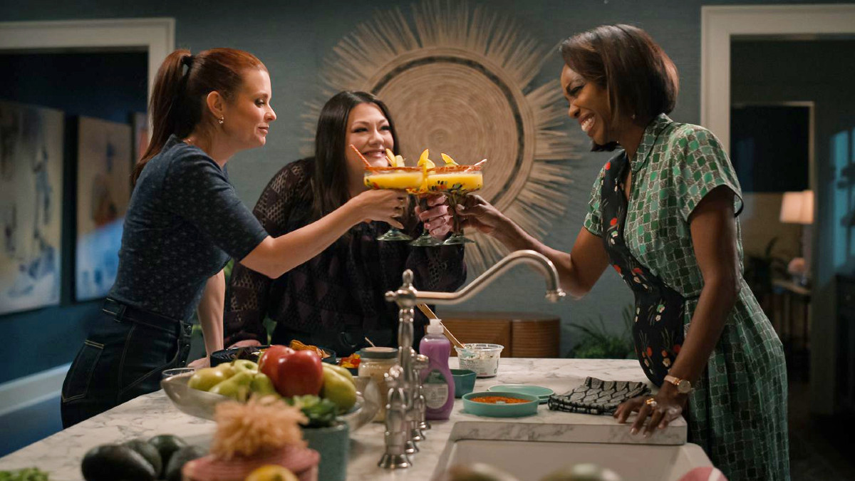 JoAnna Garcia Swisher as Maddie, Brooke Elliot as Dana Sue, and Heather Headley as Helen holding margaritas in Sweet Magnolias season 4