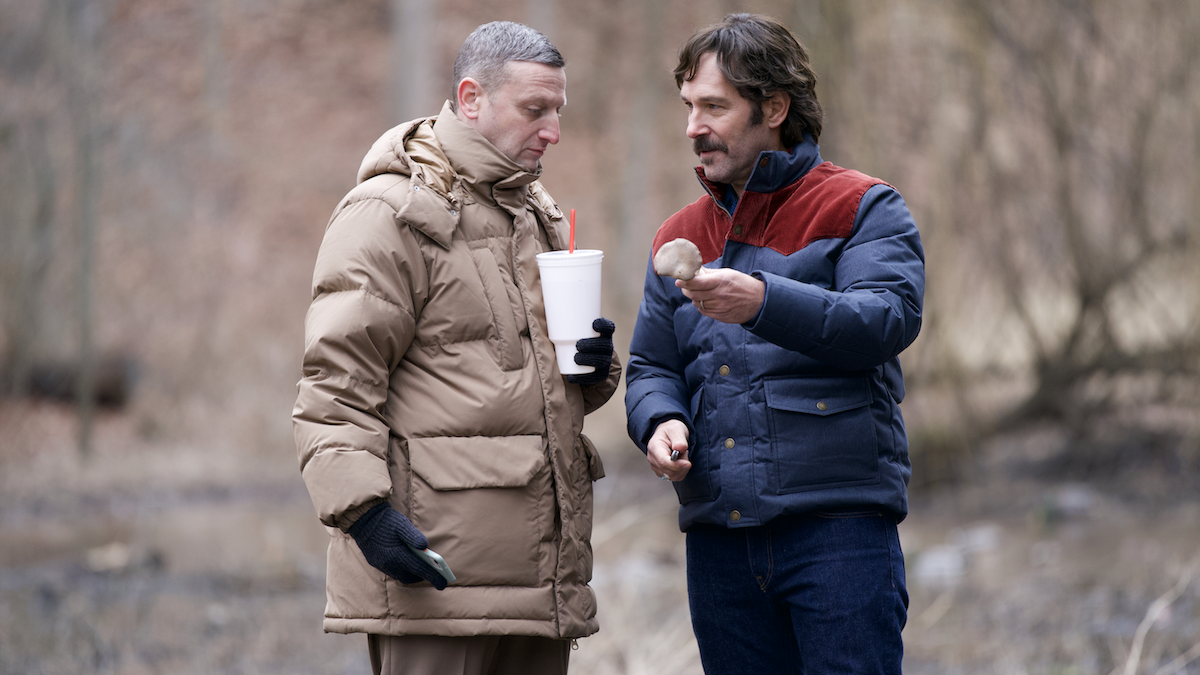 craig and austin holding mushrooms in the woods