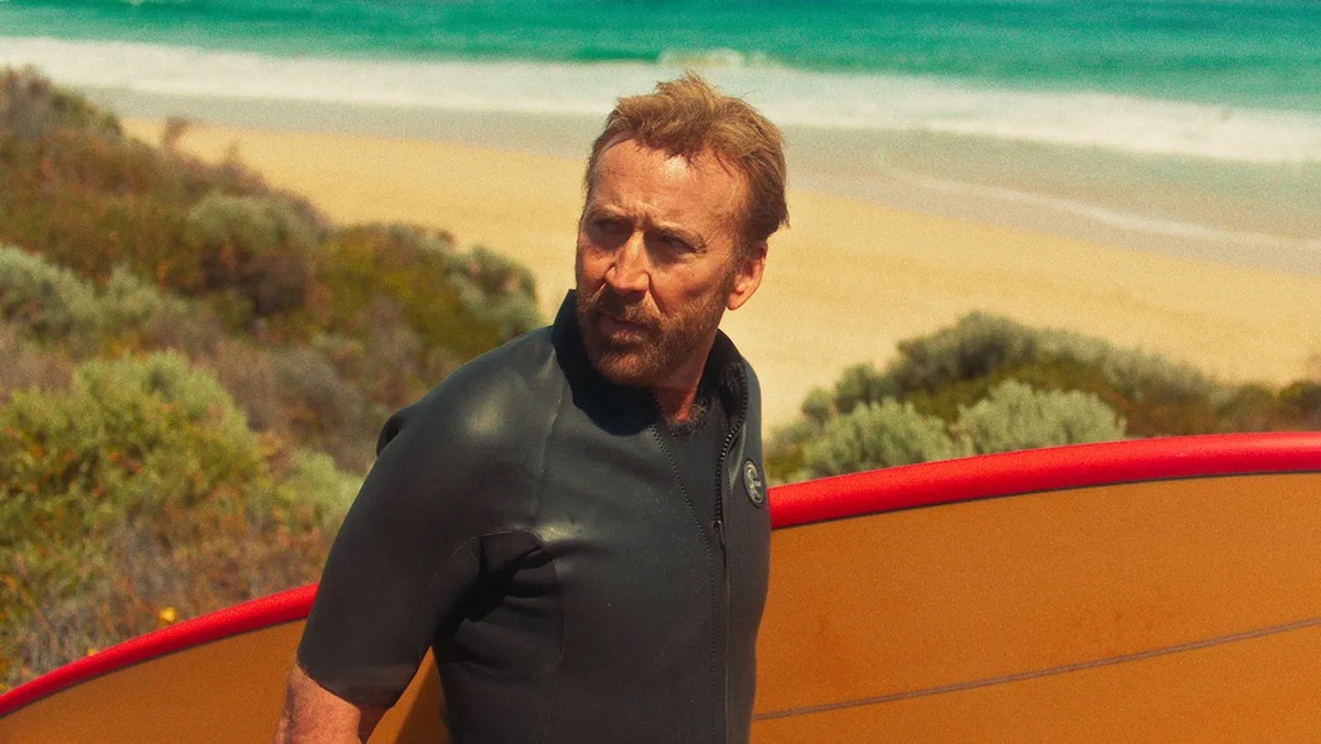 nic cage with a surf board